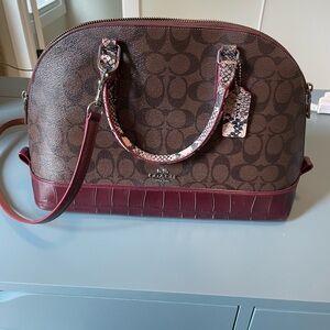 Beautiful burgundy and snake print Coach Purse